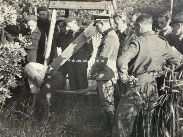 Camp commander Karl Peter Berg during the exhumation of victims