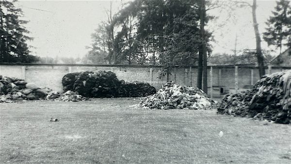 Dachau - American photograph of piles of clothing near Baracke X